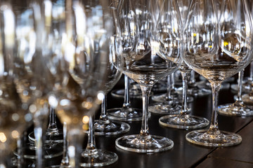 Closeup of Empty Wine Glasses in Various Shapes on a Bar Table