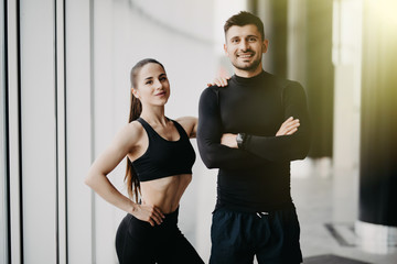 Fototapeta na wymiar Sport, fitness, lifestyle and people concept - happy sportive man and woman at gym