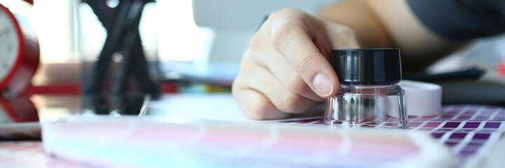 Male serviceman hold in hand magnifying glass making colour test