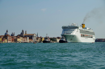 Italian luxury cruise ship Costa Victoria cruising the Giudecca Canal with tug boats towards the...