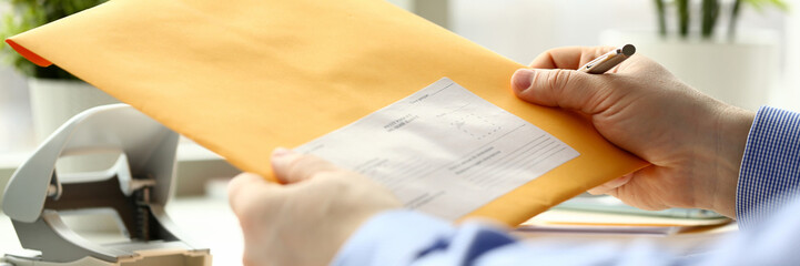 Businessman hold hand yellow mail envelope