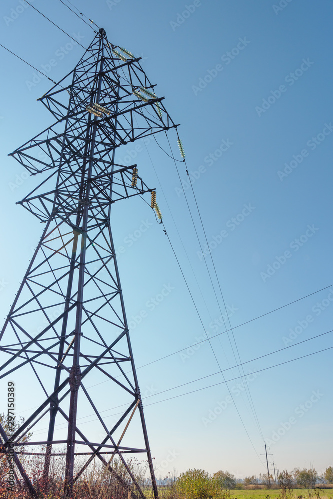 Wall mural Power lines with various poles and supports, the appearance of an electrical transformer booth.