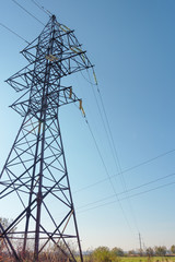 Power lines with various poles and supports, the appearance of an electrical transformer booth.