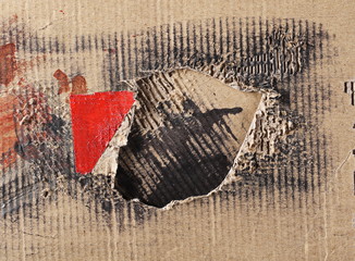 Torn and ink dirty, with red adhesive tape cardboard background and texture
