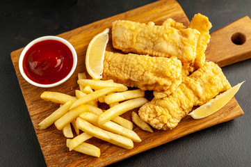 fish and chips with french fries, on a stone background