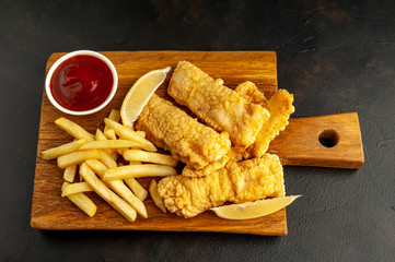 fish and chips with french fries, on a stone background