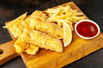 fish and chips with french fries, on a stone background