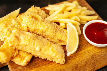fish and chips with french fries, on a stone background