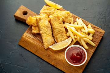 fish and chips with french fries, on a stone background