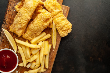 fish and chips with french fries, on a stone background with copy space for your text