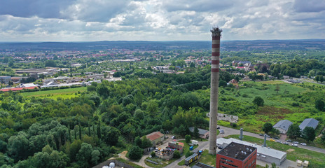 Aerial drone perspective view on high concrete chimney in heating plant close to the city