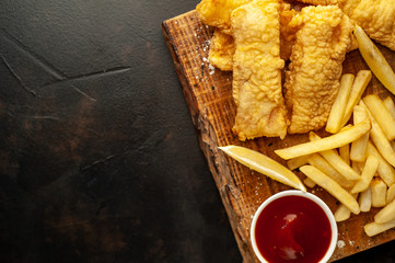fish and chips with french fries, on a stone background with copy space for your text