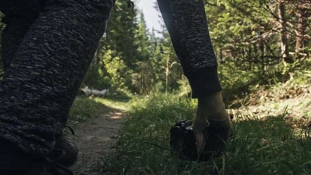 Traveler photographing scenic view in forest. One caucasian woman shooting close up look. Girl hold dslr mirrorless camera in his hand. Outdoor.