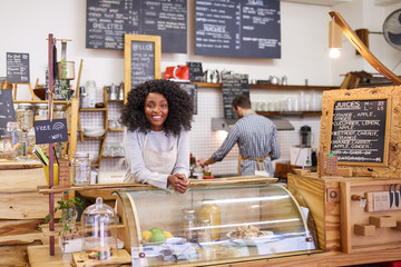 African American barista smiling while working in a cafe