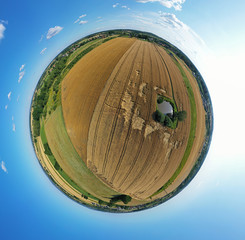 Aerial drone 360 degree panoramic view on agricultural landscape with wheat field, green water pond, meadows and forest.