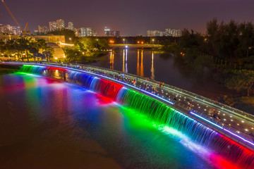Aerial view of Starlight Bridge or Anh Sao Bridge which is a pedestrian bridge with colored lights and waterfall in District 7 of Ho Chi Minh City also known as Saigon, Vietnam. 