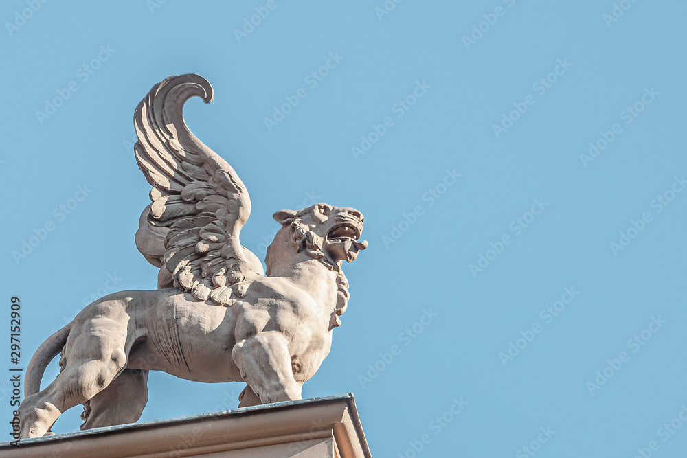 Canvas Prints roof top statue of a sphynx, lion with wings in vienna downtown at blue sky, austria