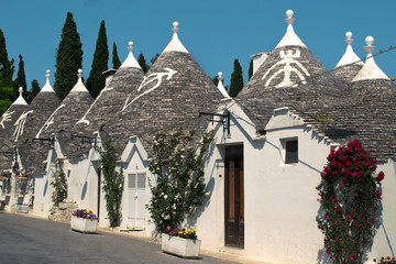 Fototapeta na wymiar Street with unique white buildings with conical roof called 