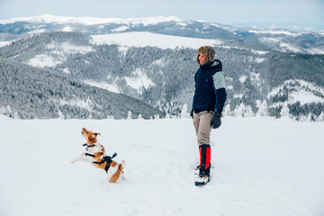 Lone trekker with his dog in snow.