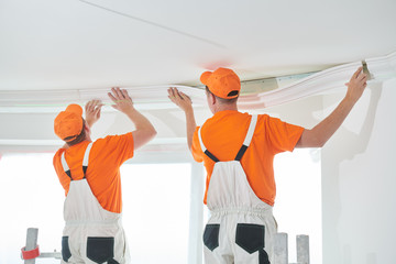 installing decorative ceiling molding. home repair and decoration © Kadmy