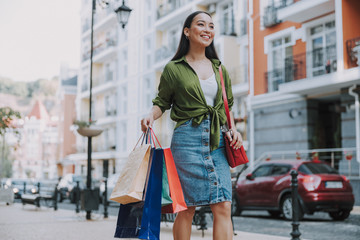 Smiling young woman looking away in the city