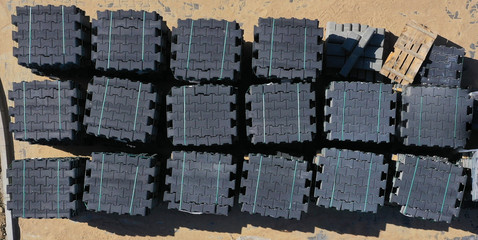 Aerial drone top down view on sanded new brick pavement with bricks stack stored for future use