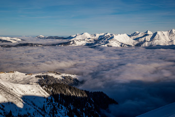 Inversion in valley and illuminated mountain peaks