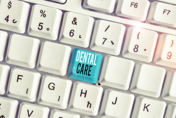 Writing note showing Dental Care. Business concept for maintenance of healthy teeth or to keep it clean for future White pc keyboard with note paper above the white background