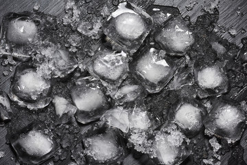 Heap of crushed melting ice cubes on the black background