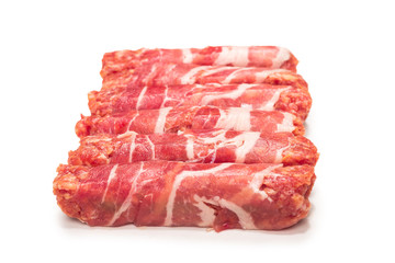 Chevapchichi in bacon isolated on white background.