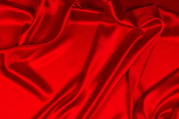 Obraz premium Red silk or satin luxury fabric texture can use as abstract background. Top view