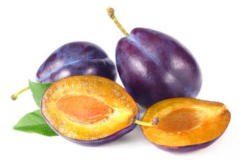 fresh plum fruit with green leaf and cut plum slices isolated on white background