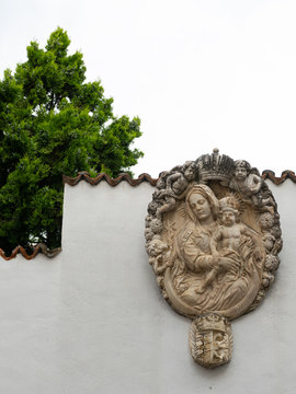 A relief of madonna and child on a white wall in Schlanders