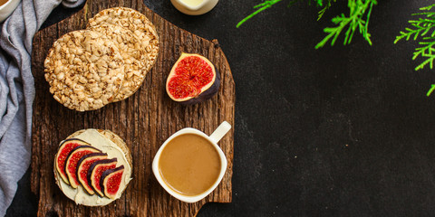 healthy food, sandwich, crisp bread, figs, coffee (breakfast or snack, cream cheese, butter, yogurt) menu concept. food background. copy space. Top view