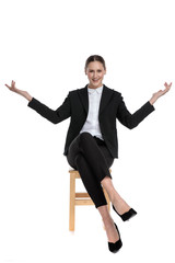 businesswoman sitting with crossed legs and open arms