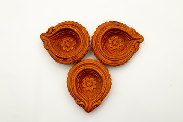 Colorful clay diya lamps lit during diwali celebration