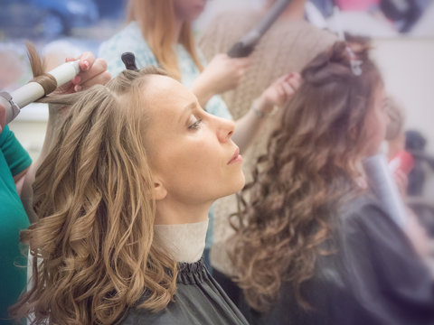 Curling curls, creating a beauty image. Toning. 