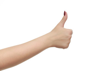 Female hand with a beautiful manicure showing thumbs up sign, isolated on white background.