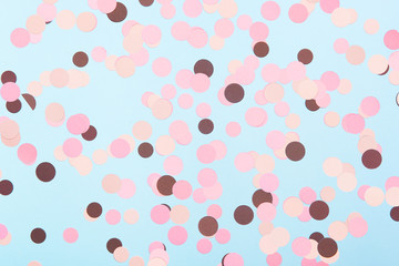 Abstract multicolored confetti on mint blue textured background. Pastel polka dots texture. Flat lay style.