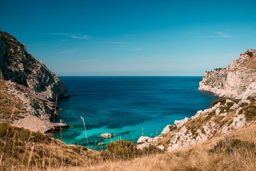 View from above of the beautiful Cala Blanca, Andratx with a turquoise waters and spanish nature landscape with blue bright summer sky. Mallorca, Balearic Islands