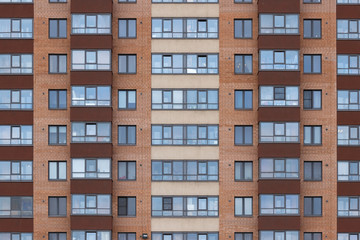 Modern architecture brick facade high rise residential building front view.