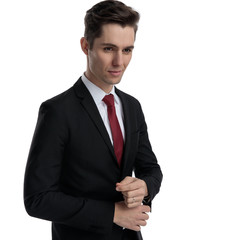 Charming businessman adjusting his sleeve