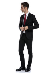 Elegant businessman and unbuttoning his jacket