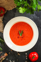 gazpacho, tomato or carrot soup with vegetables (delicious feather dish, healthy cooking) menu concept. food background. copy space. Top view