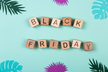 Black friday sale shopping concept alphabet on wooden blocks. Design concept for social media and banners on mint background.