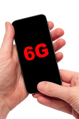 Male hand holding a smartphone with text 6G
