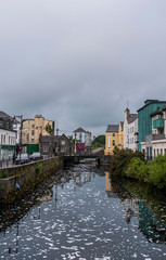 View of the River Corrib flowing through Galway City center with the old buildings.