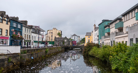 Fototapeta na wymiar View of the River Corrib flowing through Galway City center with the old buildings.