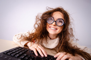 Funny nerd girl working on computer