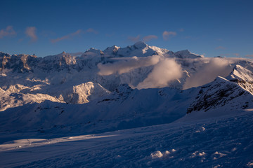 Sunlit valley and clouds under Mont Blanc
